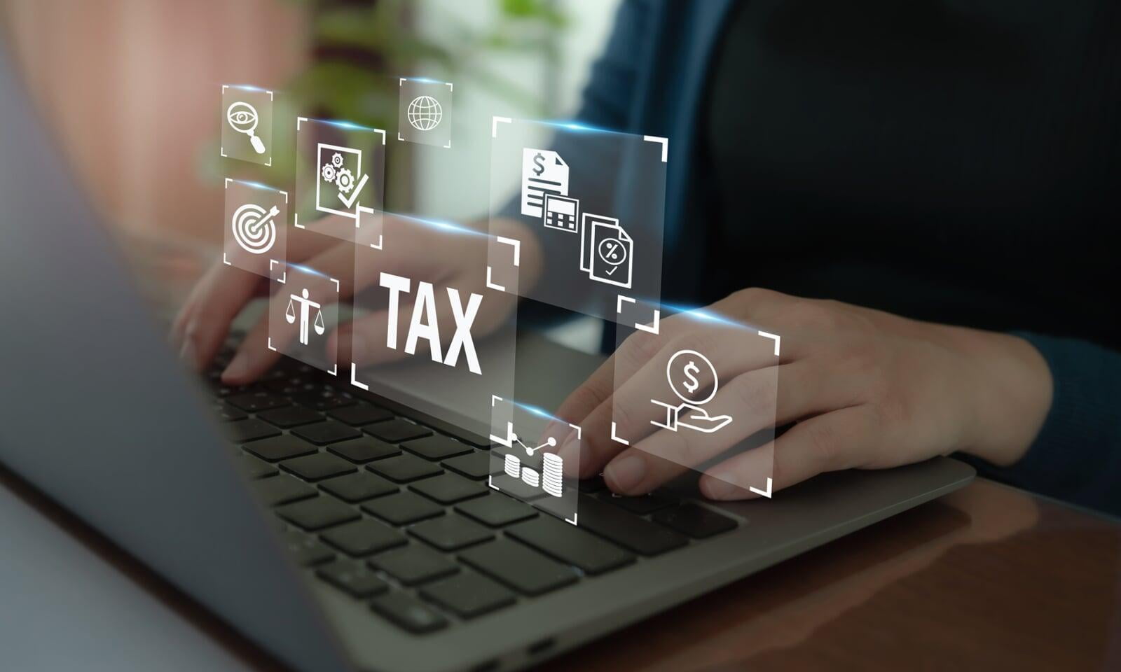 Tax and accounting software page cover photo of a woman typing on the computer.
