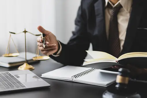 Business man looking at notepad at his desk.