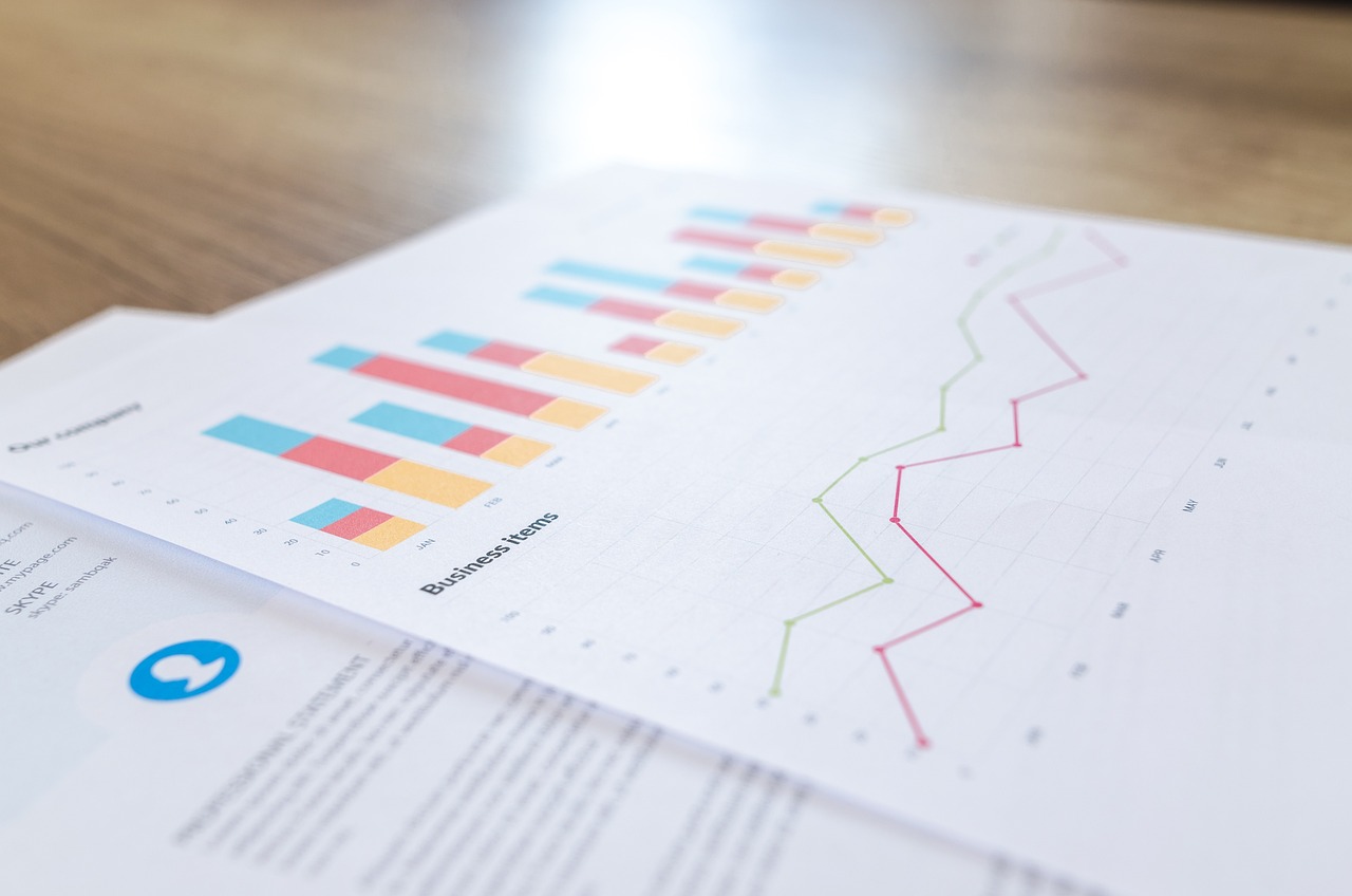 Statistics and graphs on an image on the desk.